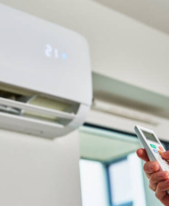 Melbourne Heating and Cooling technician operating an air conditioner