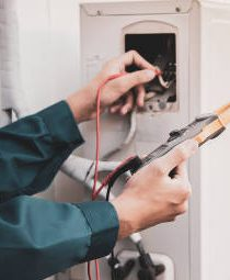 Technician performing electrical checks during air conditioning replacement in Melbourne