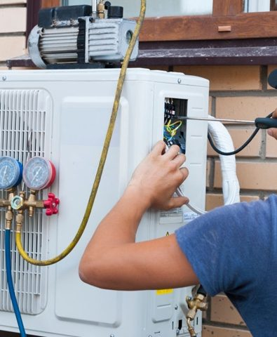 MHC technician servicing an air conditioner