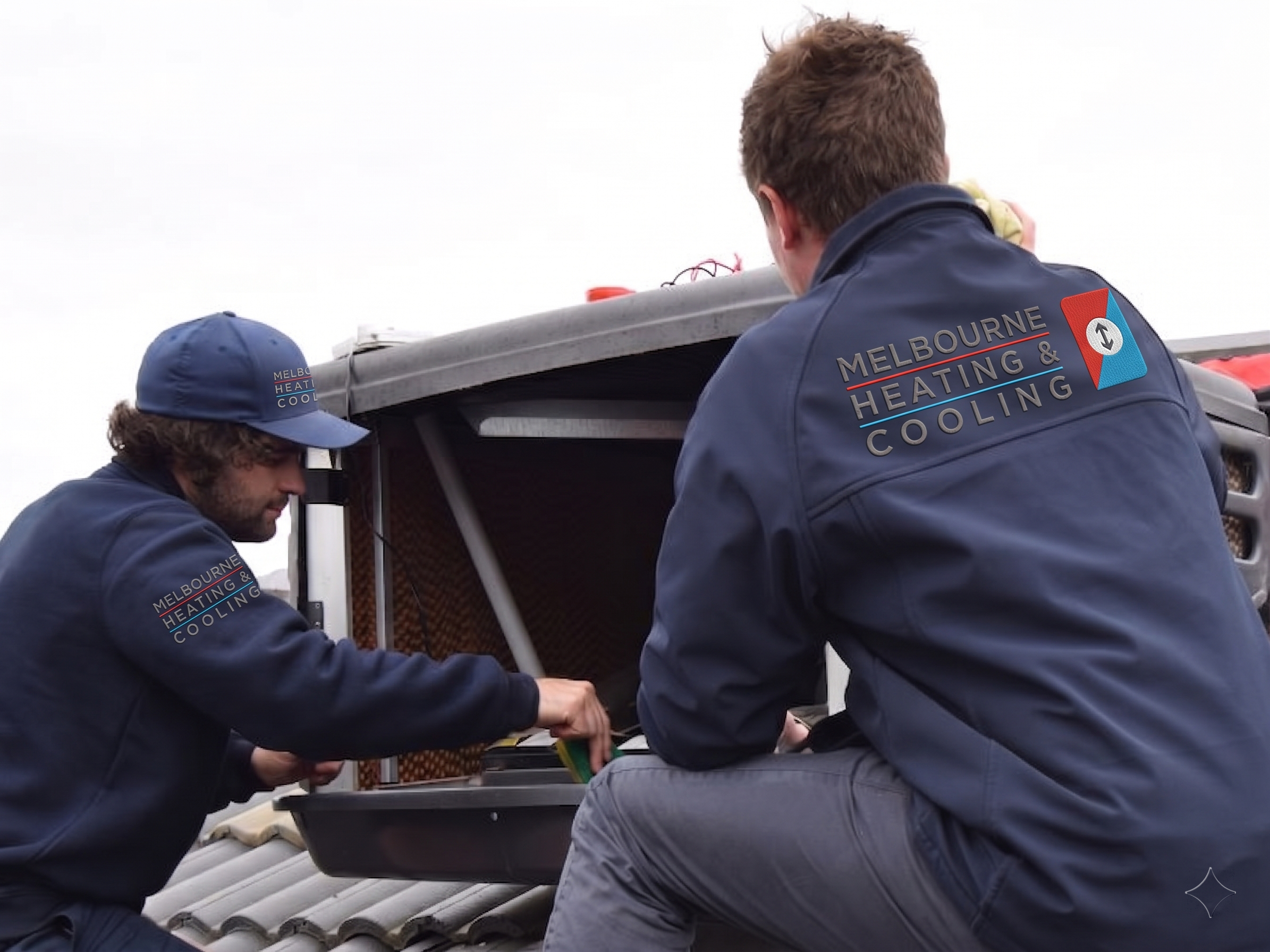 Melbourne Heating and Cooling technicians servicing an evaporative cooler on a rooftop