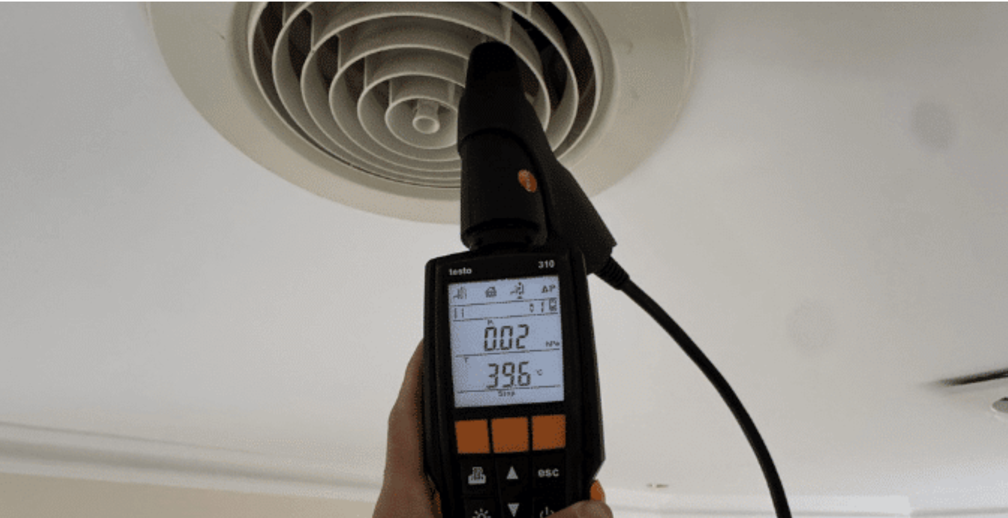 Technician testing airflow at a ducted air conditioning vent in Melbourne