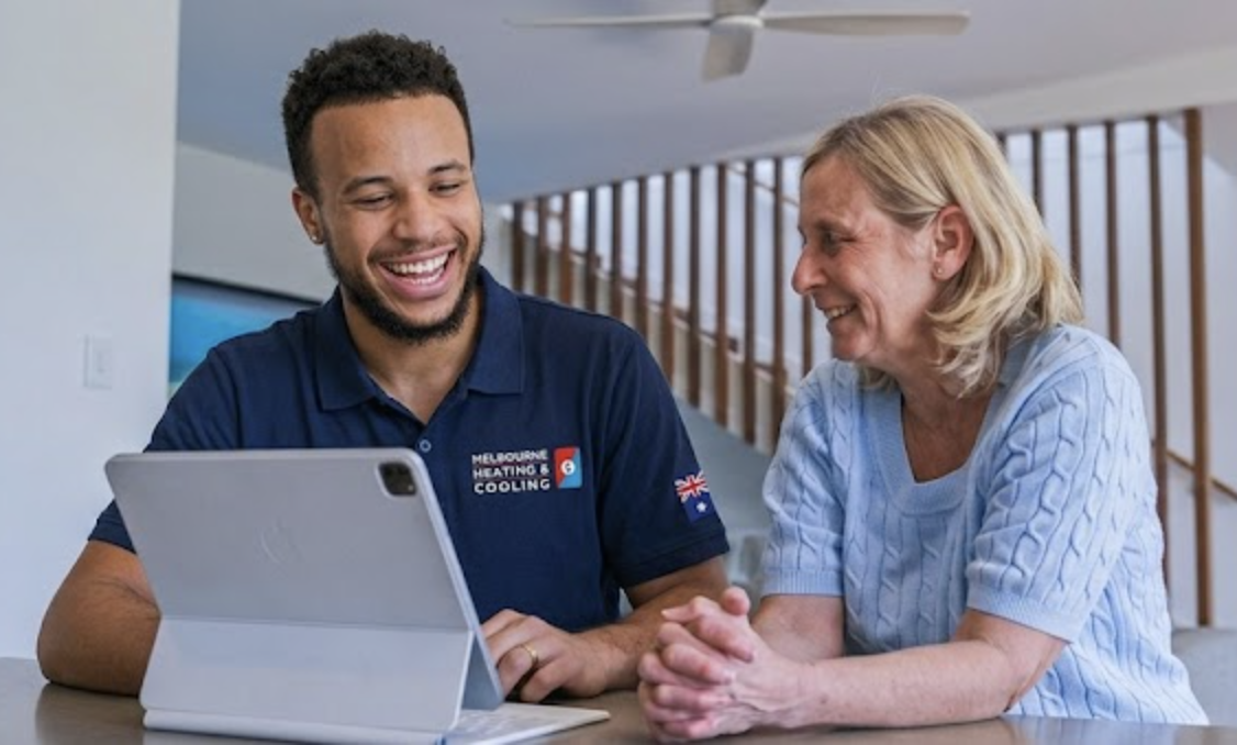 Melbourne Heating and Cooling technician reviewing service schedule with a homeowner